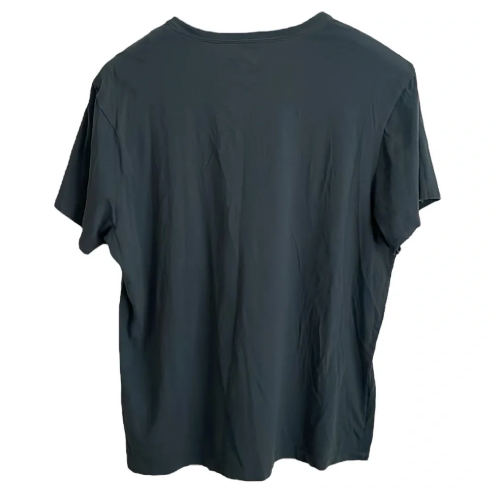 J. Crew washed 100% cotton men’s Size 2XL t-shirt. Color is a‎ dark teal blue.